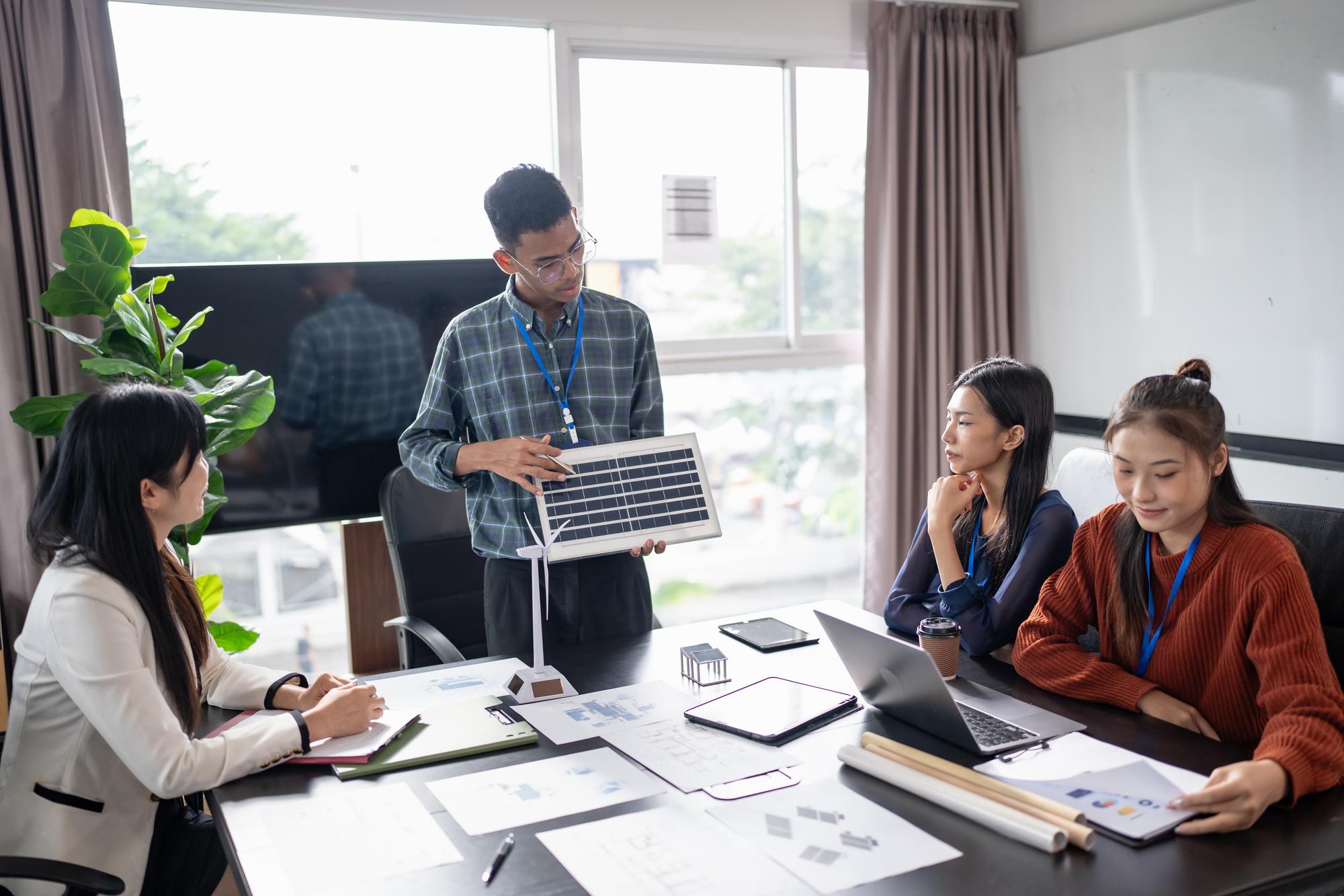 Professional team members collaborating in modern office workspace